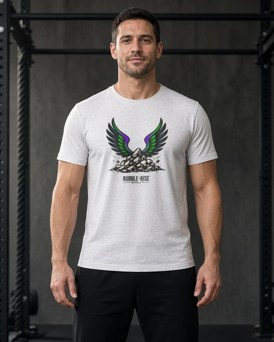 Man in a dark gym wearing the Rubble and Rise Take Flight graphic tee in Ash