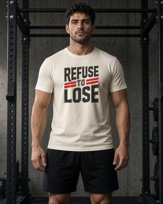 Man in a dark gym wearing the Rubble and Rise Refuse to Lose motivational tee in Natural